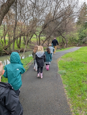 Elementary students walking down the fish ladder path with a Sonoma Watertour guide.